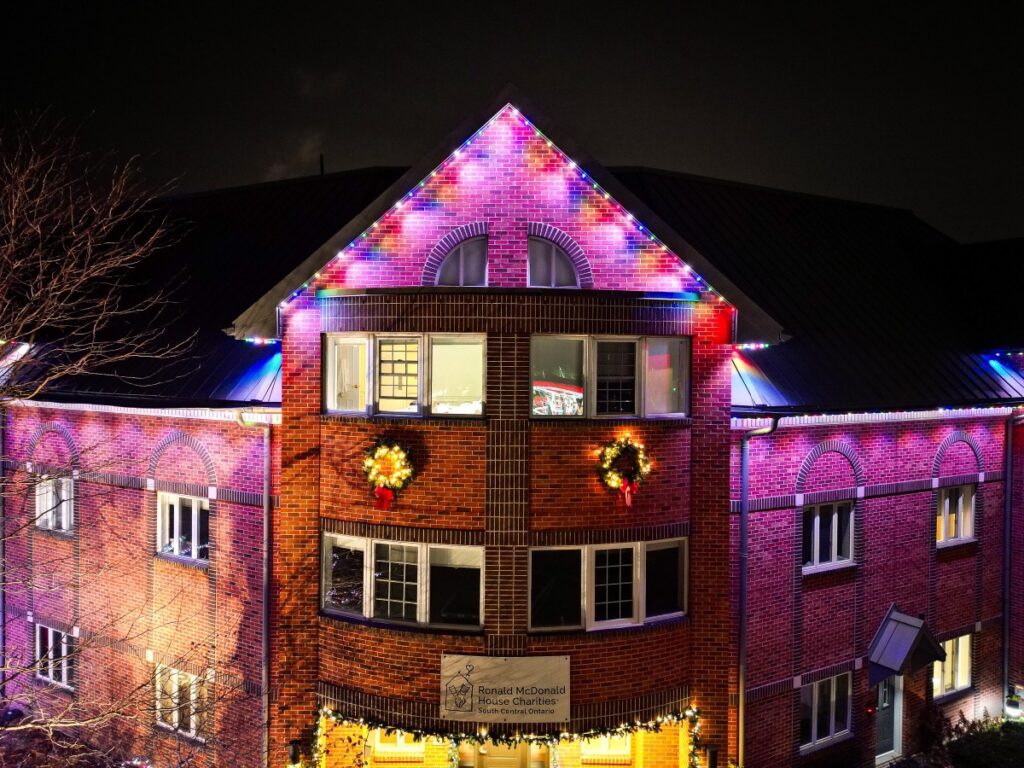 Colourful roofline lighting on a brick building at Ronald McDonald House South Central Ontario.